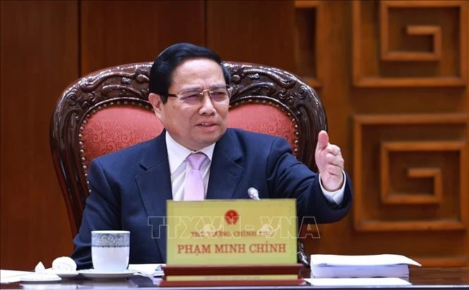 Prime Minister Pham Minh Chinh speaks at the meeting on Government restructuring in Hanoi on January 13. (Photo: VNA)