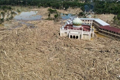 An aerial view shows vast remains of uprooted trees at the Darul Mukhlisin Islamic boarding school and mosque in the aftermath of flash floods at Aceh Tamiang in Northern Sumatra on Dec 10, 2025. (Photo: AFP)