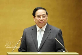 Prime Minister Pham Minh Chinh presents the action plan for implementing the Resolution of the 14th National Party Congress at the conference on February 7. (Photo: VNA)