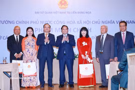 PM Pham Minh Chinh (centre) presents gifts to the Vietnamese community in Russia at the meeting in Moscow on late March 22 (local time). (Photo: VNA)
