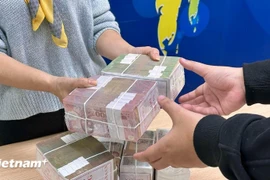 Since early July, some commercial banks have moved to slightly lower their rates. (Photo: VNA)