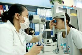 Children with refractive errors are now eligible for health insurance coverage for eye exams starting this July. (Photo: VNA)