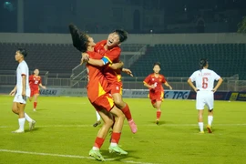 Vietnamese players celebrate a goal at the match against Myanmar on June 9 (Photo: VNA)