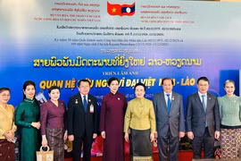 Madame Ngo Phuong Ly (fifth from left), Madame Naly Sisoulith (sixth from left), and officials of the two countries at the opening ceremony of the Vietnam Film Week and the photo exhibition on December 2 (Photo: The thao & Van hoa newspaper)