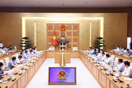 Prime Minister Pham Minh Chinh addresses a conference reviewing one month of running the two-tier local administration system on July 28. (Photo: VNA)