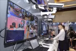 Visitors at an exhibition showcasing technology devices for cybersecurity. (Photo: VNA) 