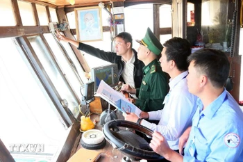 Checking voyage monitoring system on a fishing boat (Photo: VNA)