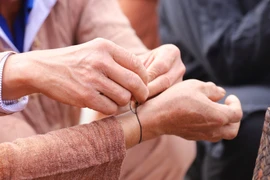 Decoding the wrist-tying and naming rituals of the O Du people