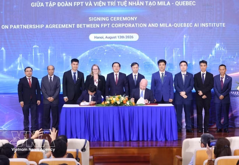 Deputy Prime Minister Ho Quoc Dung (fifth from left) and delegates witness the signing of the strategic cooperation agreement for the next phase between FPT Corporation and Mila – Quebec AI Institute of Canada. (Photo: VNA)