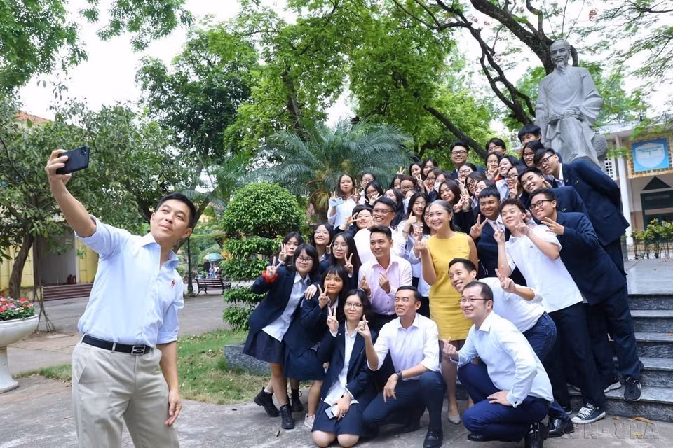 Speaker of the Parliament of Singapore Tan Chuan-Jin takes a selfie with students in front of teacher Chu Van An’s statue in the courtyard of Chu Van An high school in Hanoi (May 19, 2022). (Photo: VNA)