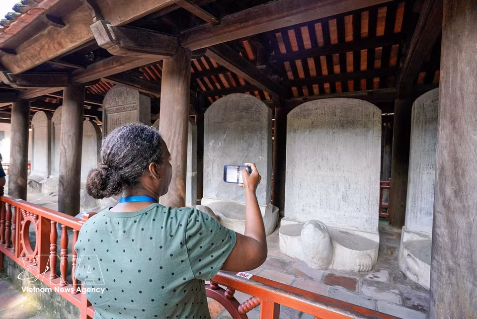 An international delegate takes a photo of the stone stelae at the Temple of Literature in Hanoi. (Photo: VNA)