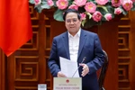 Prime Minister Pham Minh Chinh addresses the meeting meeting between the permanent Government members and leaders of Hanoi to review and provide feedback on the draft Hanoi Capital Master Plan with a 100-year vision on March 14. (Photo: baochinhphu.vn)