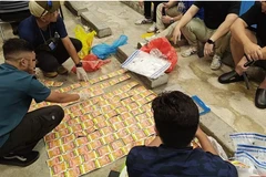 Health Sciences Authority officers counting the seized smokeless tobacco products. (Photo: HSA)