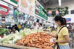 Customers shop at a supermarket in HCM City. (Photo: VNA)