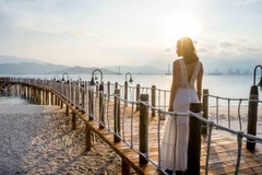 A visitor enjoys the sunrise in Nghi Duong, Phu Quoc island (Photo: VietnamPlus) 