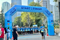 Around 500 people join in a five-kilometre run or walk and several “green action” events to kick off the week. (Photo: VNA)