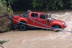 The pickup truck drove through the flooded road, and swept into a swollen roadside creek. (Photo: Cebudailynews)