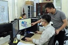 Engineers of Tomeco company in Hanoi's Ngoc Liep Industrial Cluster discuss industrial fan design (Photo: VNA)