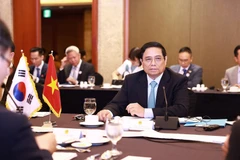 Prime Minister Pham Minh Chinh at the working lunch. (Photo: VNA)
