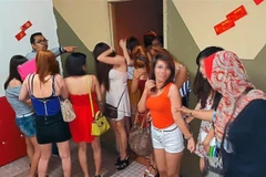 Malaysian police arrest 56 foreign women in raid