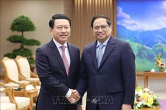 PM Pham Minh Chinh receives Lao Deputy PM, Foreign Minister