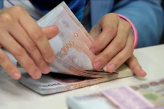 Thai baht surges on prospect of tourism recovery