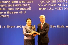 Vietnamese, Lao embassies in China hold friendship exchange