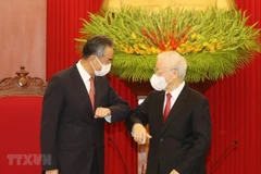 Party General Secretary Nguyen Phu Trong (R) greets Wang Yi, State Councilor and Foreign Minister of China (Photo; VNA)