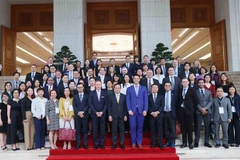 Deputy PM Tran Luu Quang and delegates (Photo: VNA)