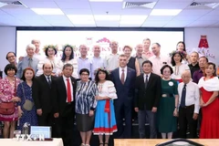 Participants pose for a group photo at the get-together in HCM City on November 5. (Photo: VNA)