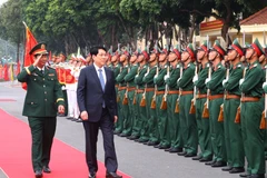 State President Luong Cuong reviews the guard of honour (Photo: VNA)