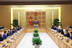 Prime Minister Pham Minh Chinh receives a delegation of aerospace, defence and security companies under the US-ASEAN Business Council (USABC) in Hanoi on December 18. (Photo: VNA)