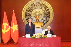 Party General Secretary and State President To Lam (standing) talks with the staff of the Vietnamese Embassy and representatives of the Vietnamese community in China. (Photo: VNA)