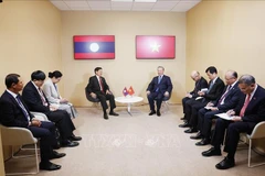The meeting between General Secretary of the CPV Central Committee and State President To Lam (right) and General Secretary of the LPRP Central Committee and President of Laos Thongloun Sisoulith in Paris on October 5 (Photo: VNA)