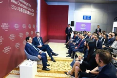 PM Pham Minh Chinh and other participants at the dialogue in Dalian city, China, on June 25. (Photo: VNA)
