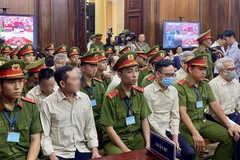 Defendants involved in the Vietnam Register corruption case at the first-instance trial opened in HCM City on July 18. (Photo: VNA)