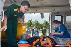 Fisherman with stroke brought from Song Tu Tay island to mainland for treatment