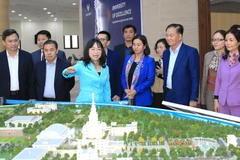 Lao Party officials visit Hanoi craft village, university