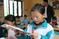 Young Vietnamese students improving reading abilities 