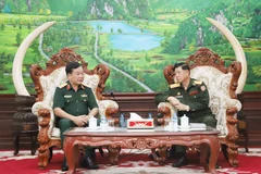 Vietnamese Deputy Minister of National Defence Sen. Lieut. Gen Hoang Xuan Chien (left) and his Lao counterpart Vongkham Phommakon at their meeting in Vientiane on October 9. (Photo: VNA)