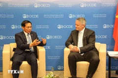 Minister of Foreign Affairs Bui Thanh Son (left) and OECD Secretary-General Mathias Cormann. (Photo: VNA)