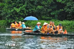 Foreign tourists visit Trang An Scenic Landscape Complex, Ninh Binh (Photo: VNA)