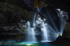 Exploring waterfall in million-year-old cave