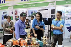 People are at a display booth at the Agri Vietnam 2024. (Photo: VNA)