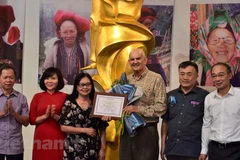 Admiring Vietnamese ethnic minority objects collected by American doctor