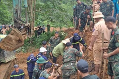 Rescuers search for victims buried by the landslide in Ha Giang province on July 13. (Photo: VNA)