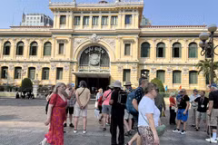 Foreign tourists seen in front of the HCM City Post Office in the downtown area. (Photo: VNA)