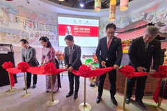 Delegates cut the ribbon to open the exhibition “President Ho Chi Minh – A Symbol of Peace and Friendship.” (Photo: VNA)