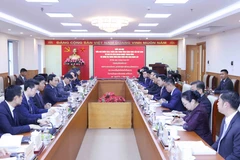At the working session (Photo: VNA)