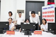 Leaders of Yen Hoa ward in Hanoi inspect the IT system on the first day of piloting the two-tier local administration model. (Photo: VNA)